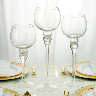 Elegant glass goblets in three sizes on a beautifully set dining table.