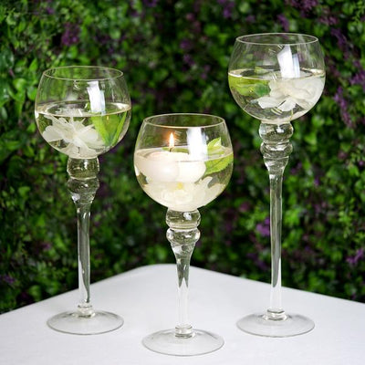 Elegant glassware with floral accents on a green backdrop.