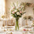 Elegant wedding table centerpiece with white and pink roses in a glass vase