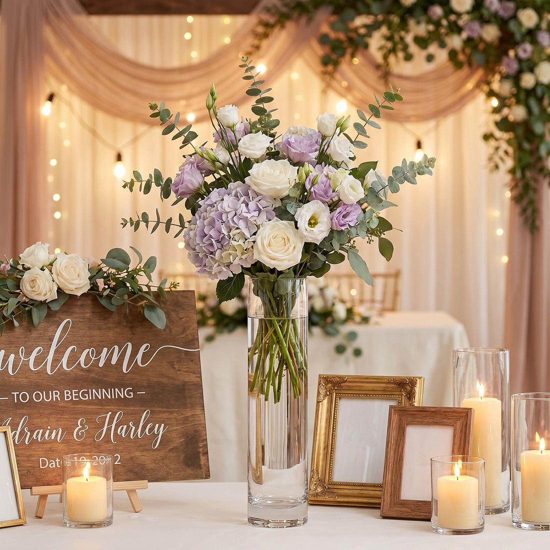 Wedding welcome table with floral centerpiece, candles, and wood sign
