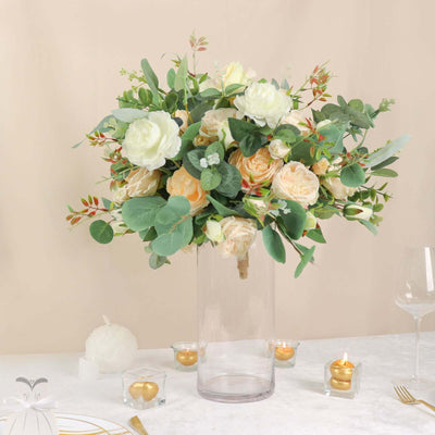 Elegant floral arrangement in a clear vase with soft blooms and greenery.