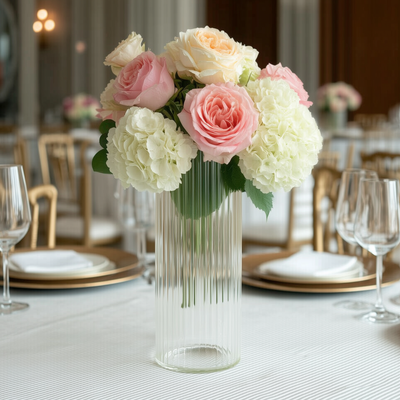 Elegant floral arrangement with pink and white roses in a glass vase.