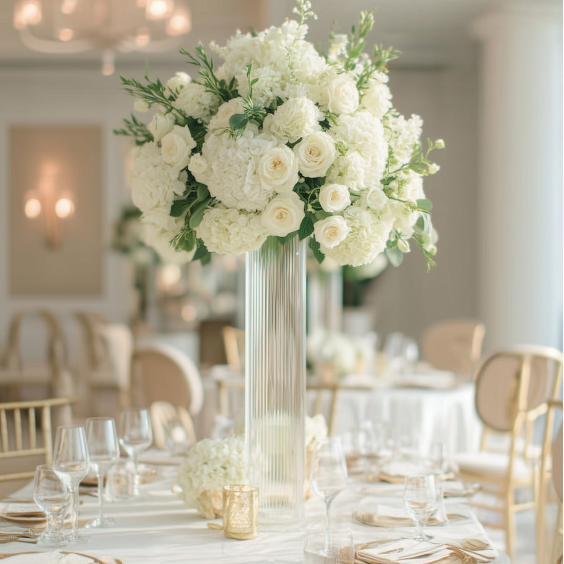 Elegant white floral centerpiece in a stylish event setting.