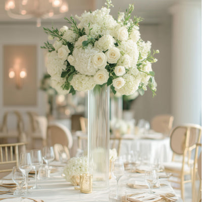 Elegant white floral centerpiece in a stylish event setting.