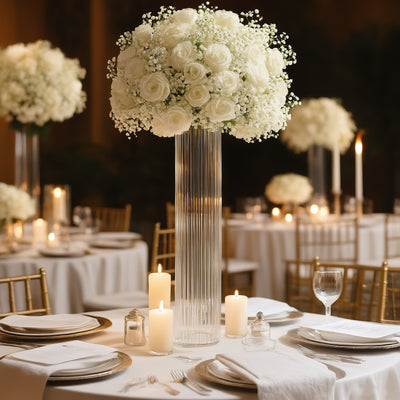Elegant floral centerpiece with white roses and baby's breath on a dining table.