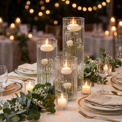 Elegant candlelit wedding table centerpiece with flowers and gold place settings