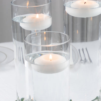 Floating candles in glass vases with water