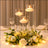 Elegant candle centerpiece with flowers and soft lighting for events.