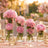 Pink peony and rose centerpieces in glass vases with candlelit wedding decor