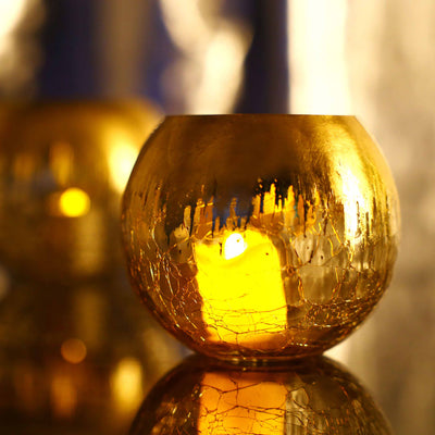Gold decorative candle holder with a warm glow.