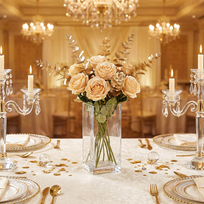 Elegant gold wedding table centerpiece with roses, candles, and crystal decor