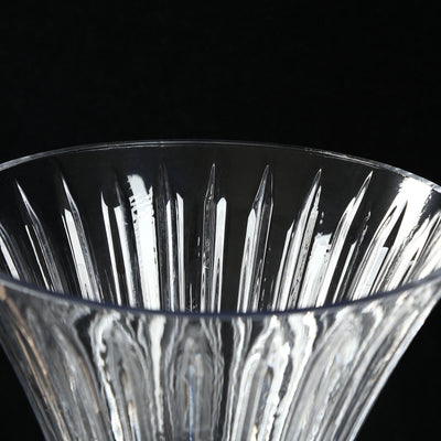 Close-up of a cut crystal glass bowl with faceted detailing on black background