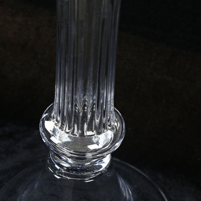 Close-up of a clear glass bottle neck on a black background