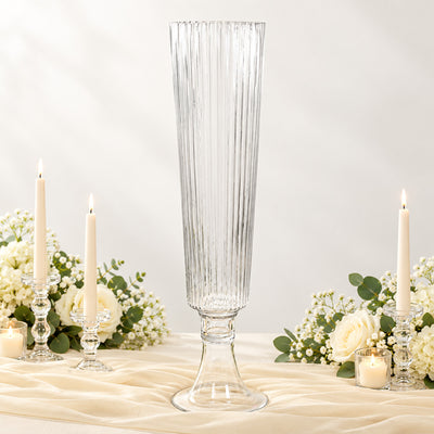 Elegant clear glass vase centerpiece with candles and white floral arrangement