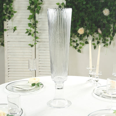 Elegant tall glass vase with ribbed design, perfect for floral arrangements.