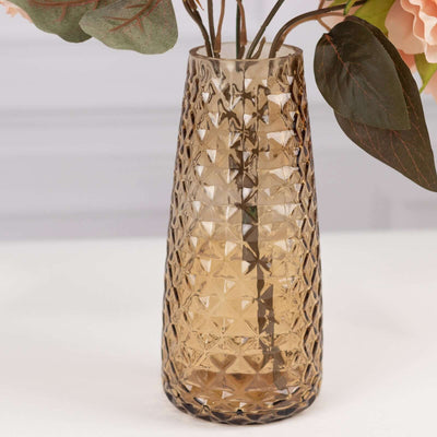 Textured glass vase in amber tones with floral arrangement.