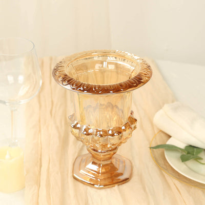 Elegant golden glass vase with decorative pedestal.