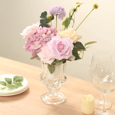 Elegant floral arrangement in a crystal vase with assorted flowers and greenery.