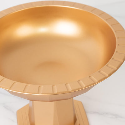 Gold bowl on pedestal with a smooth finish.