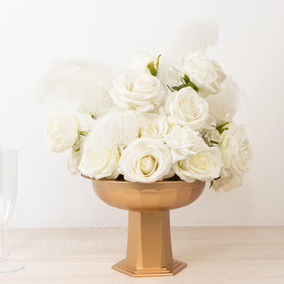 Elegant white rose arrangement in a gold pedestal vase.
