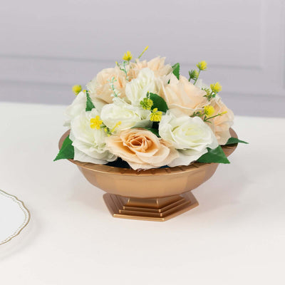 Peach and white floral arrangement in a gold bowl.
