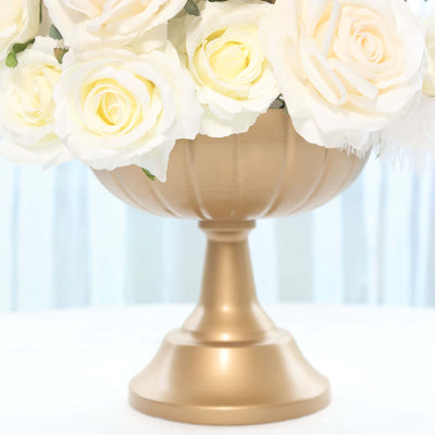 Gold decorative vase with white roses.