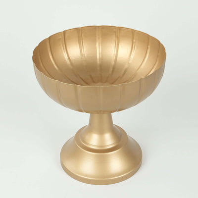Gold decorative bowl on a pedestal with ribbed design.