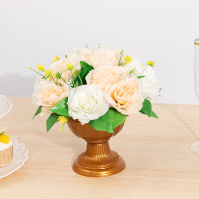 Elegant faux flower arrangement in a gold vase for home decor.