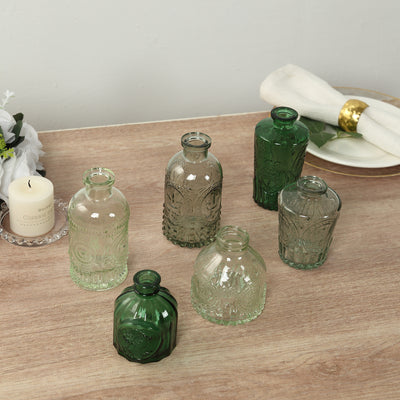 Decorative glass vases in various shapes and sizes on a wooden table.