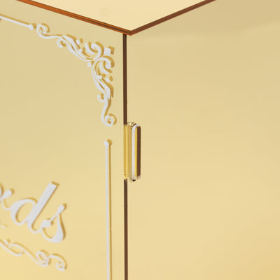Gold acrylic display box with elegant white lettering detail.