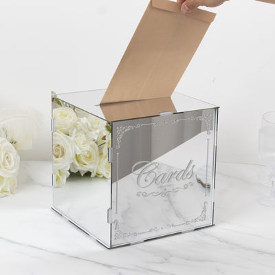 Elegant acrylic wedding card box with mirrored finish and decorative engraving.