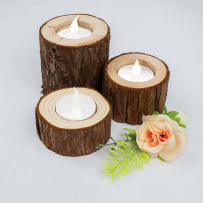 LED tealight candles in rustic wood holders with faux flower accents.