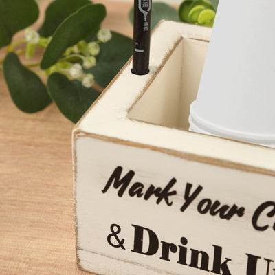 Wooden organizer box for pens and cups with decorative text.