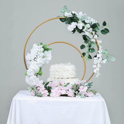 Decorative wedding cake with floral accents and circular backdrop.