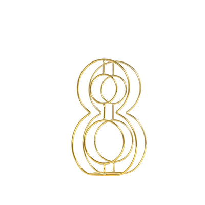 Gold decorative sculpture in an abstract number 8 shape.