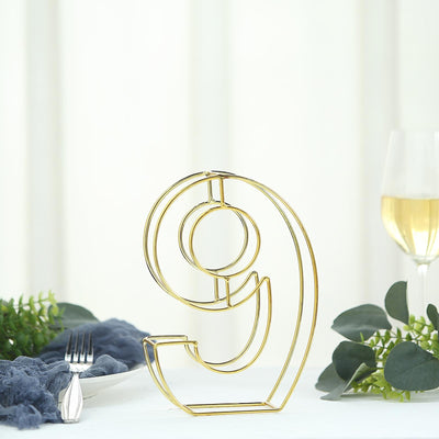 Gold number 9 decorative sculpture on a white background