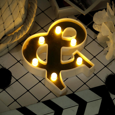 Decorative ampersand light with glowing bulbs on patterned surface.