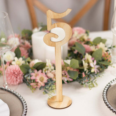 Wooden table number 5 centerpiece in a floral arrangement.