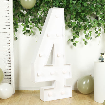 Large decorative number 4 with lights in a festive setting.