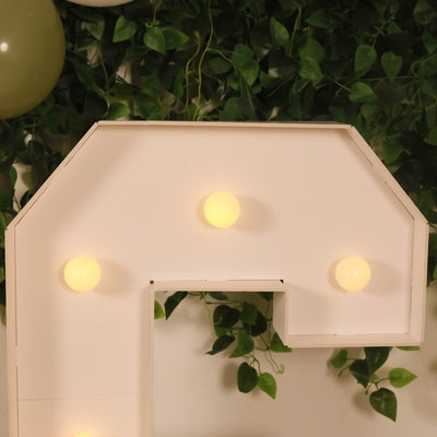 Decorative light-up letter display with soft glowing bulbs.