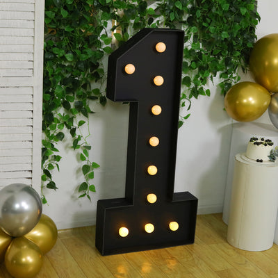 Giant black marquee number one with lights for party decorations.