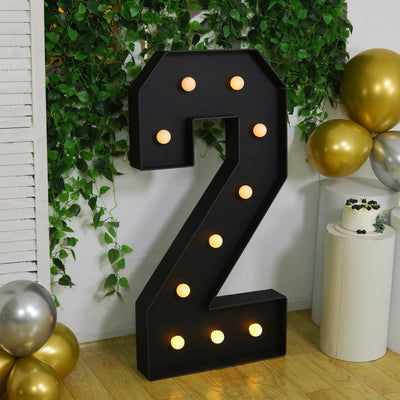 Large illuminated number two with bulbs, perfect for party decoration.