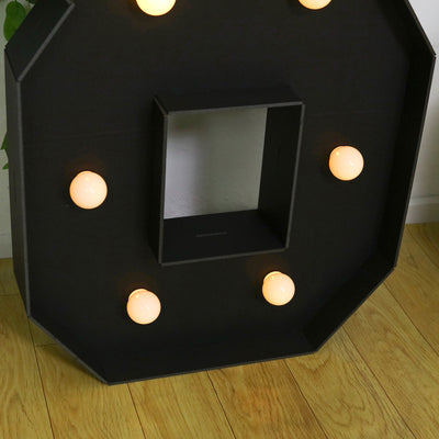 Black octagonal light-up sign with six bulbs and a central cutout.
