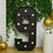 Large black marquee number 9 with lights, surrounded by greenery and gold balloons.
