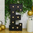Large illuminated letter 'E' on a backdrop of greenery and balloons.
