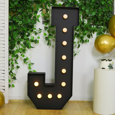 Light-up letter "J" marquee sign with bulbs, perfect for events and celebrations.