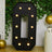 Large black marquee letter "O" with lights, surrounded by greenery and decor.