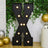Black marquee letter "X" with lights, decorated with greenery and balloons.