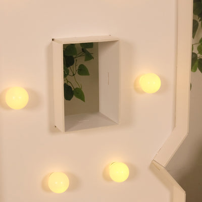 Lighted wall decor with yellow bulbs and a cutout section for plants