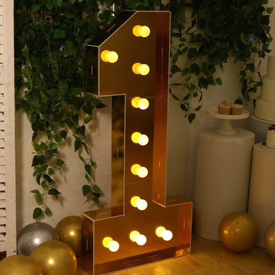 Gold number one marquee light with bulbs, perfect for celebrations.